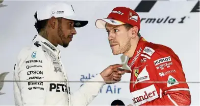  ??  ?? You talkin’ to me?: Ferrari’s Sebastian Vettel (right) listening to Mercedes’ Lewis Hamilton after winning the Bahrain Formula One Grand Prix on April 16. — AP
