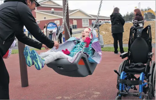  ?? ANDREW WATERMAN/ SPECIAL TO THE TELEGRAM ?? Teacher Lourdes Macdonald pushes St. Andrew’s student August Matchim on a swing at the new Jeremy Cross Memorial Playground on Thursday. August was all smiles during the opening of the playground, as were many of her classmates. The playground, which is located behind the Easter Seals House on Mount Scio Road, is the most accessible playground east of Montreal. August said she is sometimes weary of other swings because they can be too high, but she wasn’t afraid of the ones at the Jeremy Cross Memorial Playground.