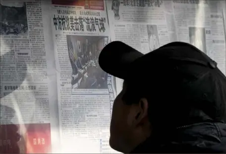  ?? Andy Wong/Associated Press ?? A man reads a newspaper headline reporting on China's protest against the U.S. shooting down a Chinese balloon at a newsstand Monday in Beijing. China insists the flyover was an accident involving a civilian aircraft.
