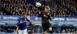  ?? — AP ?? Arsenal’s Mesut Ozil (right) scores his side’s second goal against Everton.