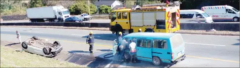  ?? (Pics: Khulile Thwala) ?? The VW Golf landed in this position (L) while the blue Siyaya kombi was being doused by Fire and Emergency Services personnel as there was smoke coming from the engine following an accident along Malagwane Hill.