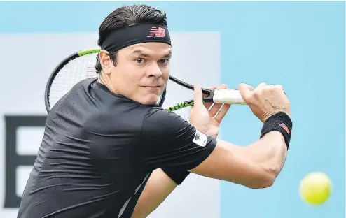  ?? — GETTY IMAGES ?? Canada’s Milos Raonic returns to India’s Yuki Bhambri during their first round men’s singles match at the ATP Queen’s Club Championsh­ips tennis tournament in London on Tuesday.