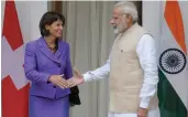  ?? — SONDEEP SHANKAR ?? Swiss President Doris Leuthard and Prime Minister Narendra Modi greet each other before talks at Hyderabad House in New Delhi on Thursday.