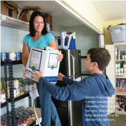  ??  ?? Senior Friendship Center volunteers Shawna Flammia and her son, Anthony, help prepare food for delivery to seniors.