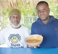  ??  ?? Rasta Ade Refreshmen­t Vegan Café’s Audley Anderson (right) shows his veggie soup, along with his coworker, Kenoley Woolery, at the 2017 TmrwTdy Culture Fest.