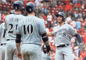  ??  ?? Ryan Braun is congratula­ted by Ben Gamel, far left, Travis Shaw and Yasmani Grandal, after Braun’s grand slam in the ninth inning Sunday.