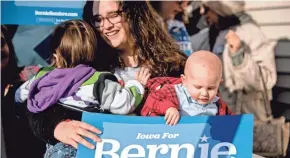  ?? ANDREW HARNIK/AP ?? Presidenti­al hopefuls were trying to stir their supporters, such as this backer of Sen. Bernie Sanders, on Sunday, the eve of the Iowa caucuses.