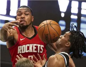  ?? — AP ?? Too close: Los Angeles Clippers guard Terance Mann (right) loses control of the ball while under pressure from Houston Rockets forward Sterling Brown during their NBA game. The Clippers won 126-109.