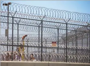  ?? Los Angeles Times ?? DETAINED IMMIGRANTS work in the yard at the Adelanto detention facility, which was f lagged in September for harsh conditions and violating ICE’s safety standards.