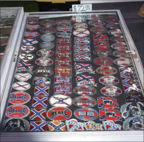  ?? PHOTO BY WILLIAM J. KEMBLE ?? Belt buckles adorned with Confederat­e stars-and-bars symbols were being sold at the Ulster County Fair in New Paltz, N.Y., on Tuesday, in violation of the fair’s policy.