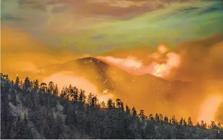  ?? KYLE GRILLOT GETTY IMAGES ?? The Bobcat fire continues to burn through the Angeles National Forest in Los Angeles County, north of Azusa. More than 18,500 firefighte­rs are battling more than two dozen major wildfires in California.