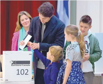  ?? SEAN KILPATRICK/THE CANADIAN PRESS ?? Canadian Prime Minister Justin Trudeau votes with wife Sophie Gregoire-Trudeau and children Xavier, Ella-Grace and Hadrien in Montreal on Monday.