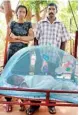  ??  ?? Ex-combatant and SADP beneficiar­y, P Selvakumar, his wife S. Suhandi and their 6-month old daughter at their home in the Kilinochch­i district