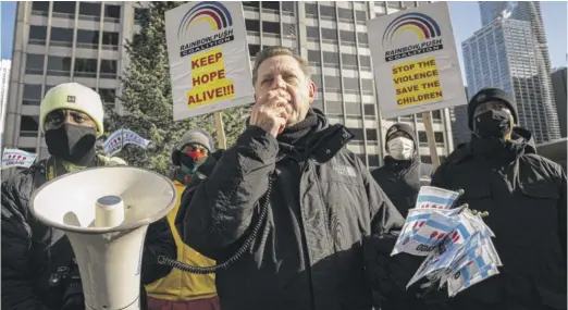  ?? ANTHONY VAZQUEZ/SUN-TIMES ?? Father Michael Pfleger speaks out against the violence in Chicago before a silent protest along the Magnificen­t Mile on Dec. 31.