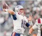  ?? Heidi Fang/TNS ?? New England Patriots quarterbac­k Mac Jones throws against the Las Vegas Raiders at Allegiant Stadium on Dec. 18 in Las Vegas.