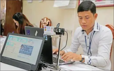  ?? HENG CHIVOAN ?? An official records a resident’s details for electronic voter registrati­on in Phnom Penh in September.