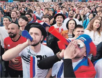  ?? OLEG NIKISHIN GETTY IMAGES ?? Fans gather at the official FIFA Fan Fest at Moscow State University to watch Thursday’s World Cup opener.