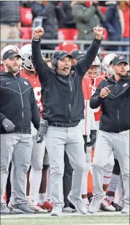  ?? AP-Tony Ding, File ?? FILE — In this Nov. 25, 2017, file photo, Michigan head coach Jim Harbaugh, center left, shakes hands with Ohio State head coach Urban Meyer, center right, after Ohio State defeated Michigan 31-20 in an NCAA college football game in Ann Arbor, Mich. Jim Harbaugh’s job is safe at Michigan whether he finally beats Ohio State or falls to 0-5, but the timing for a win would provide a boost for college football’s winningest program.