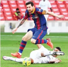  ?? photo — AFP file ?? Barcelona’s Lionel Messi (top) challenges Real Madrid’s Casemiro during the Spanish La Liga match at the Camp Nou stadium in Barcelona.