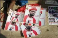  ?? RONALD KABUUBI — THE ASSOCIATED PRESS FILE ?? In this Thursday file photo, a supporter sits by posters of pop star-turned-opposition lawmaker Bobi Wine, whose real name is Kyagulanyi Ssentamu, at his home in Kampala, Uganda.