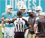  ?? CHARLES TRAINOR ctrainor@miamiheral­d.com ?? Dolphins coach Brian Flores talks with officials after the skirmish with the Bengals in the fourth quarter Sunday.