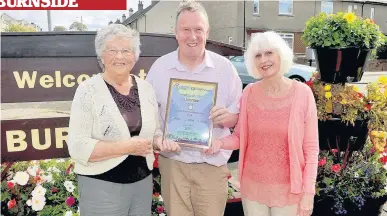  ??  ?? In bloom Joyce Davies, Malcolm Piggot and Lucille MacNab from the Burnside in Bloom team are encouragin­g youngsters to submit a photograph