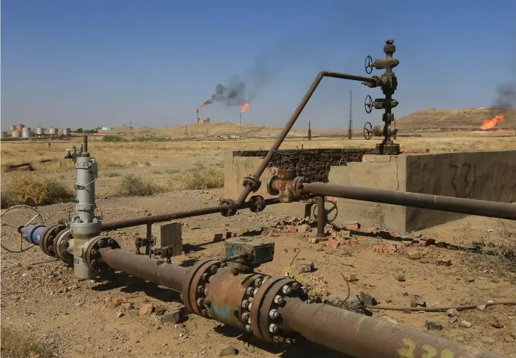  ??  ?? FLAMES EMERGE from flare stacks at the oil fields in Kirkuk in October last year.