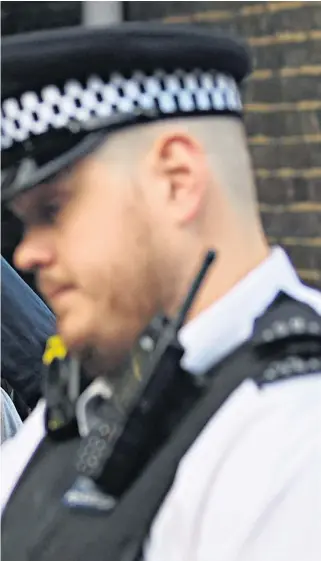  ??  ?? A police officer points the way to Dominic Cummings, the Downing Street special adviser, as he leaves his home in north London yesterday. Pressure was still mounting on him to resign for allegedly breaking coronaviru­s lockdown rules despite giving his account of his trip to Durham on Monday