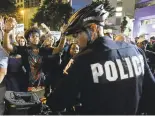  ?? JEFF SINER/THE CHARLOTTE OBSERVER ?? Protesters confront bicycle officers in Charlotte, N.C., earlier this week. California’s Department of Justice has launched an online platform to record police use of force and report the data to the public.