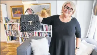  ?? TIM KROCHAK/THE CHRONICLE HERALD ?? Inside her Halifax home last week, Audrey Parker displays the Chanel purse she plans to have her cremated remains placed inside. Parker has terminal cancer and plans on an assisted death at a time of her own choosing.