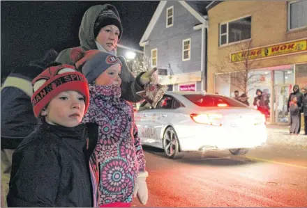  ?? COLIN MACLEAN/JOURNAL PIONEER ?? From left, Desare Leclair, Jordan Leclair and Justin Butler checked out the Downtown Summerside Santa Claus Parade Friday night.