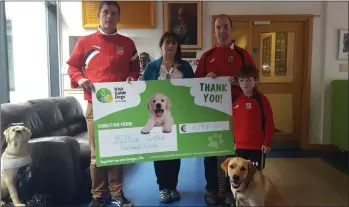  ??  ?? Mallow United’s Karol O’Donovan, Paul O’Brien and Jamie O’Brien visited the Irish Guide Dogs facility on the Model Farm Road, Cork this week where they presented a cheque for €1,175 to Anne Burns and Jodie the dog.