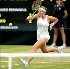  ?? AP/TIM IRELAND ?? Jelena Ostapenko chases down a ball near the net during Tuesday’s women’s singles quarterfin­al match against Venus Williams at Wimbledon. Ostapenko ran out of gas late in losing 6-3, 7-5.