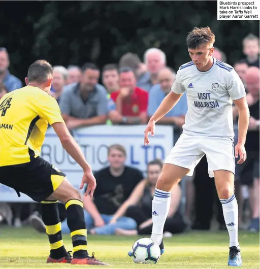  ??  ?? Bluebirds prospect Mark Harris looks to take on Taffs Well player Aaron Garrett