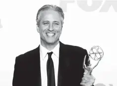  ??  ?? Stewart holds the Emmy award for the ‘The Daily Show With Jon Stewart’ at the 63rd Primetime Emmy Awards in Los Angeles, on Sept 18, 2011. — Reuters file photo
