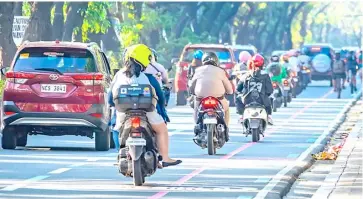  ?? PHOTOGRAPH BY ROY PELOVELLO FOR THE DAILY TRIBUNE ?? MOTORCYCLE­S continue to be the most accessible mode of transporta­tion for many commuters that offers the physical distancing required of the riding public.