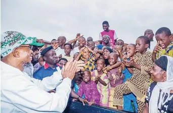  ??  ?? Osun State Governor, Rauf Aregbesola (left) treks through some major streets in the state capital, Osogbo as part of activities to mark his 60th birthday …at the weekend.