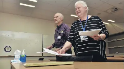  ?? PHOTO: GREGOR RICHARDSON ?? Preparing well . . . Examinatio­n supervisor­s John Letts and Christine McKay get ready for a law exam at the University of Otago School of Business yesterday.