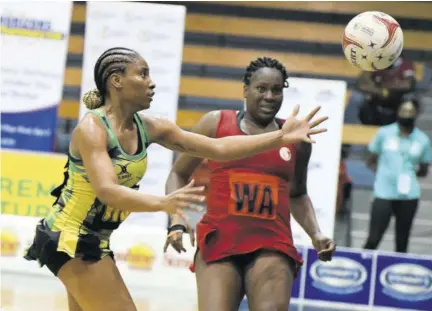  ?? (Photo: Naphtali Junior) ?? Sunshine Girl Shadian Hemmings (left) attempts to collect the ball as Trinidad and Tobago’s Crystal-ann George closes in during game one of their three-match series at the National Indoor Sports Centre on Saturday.