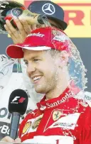  ?? ANSA ?? Doccia di champagne sul podio per Vettel