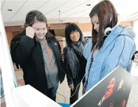  ?? BRYAN SCHLOSSER/LEADER-POST ?? Singer Buffy Sainte-Marie, centre, was at the opening of the new The Power of Music exhibit at the Royal Saskatchew­an Museum in Regina on Thursday. Pictured with Sainte-Marie looking through the exhibit are Scott
Collegiate students Sequoia Lavallee,...