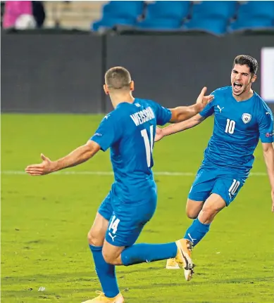  ??  ?? Manor Solomon, left, celebrates after putting Israel ahead.