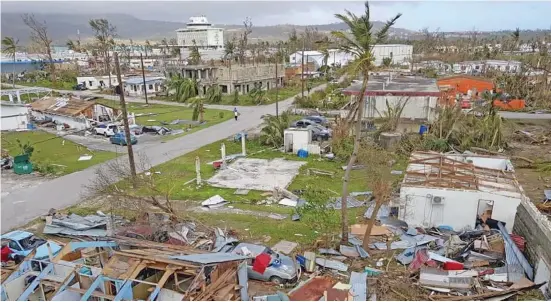  ?? Photo: Mike Babauta ?? A nearly decimated cluster of houses in central Saipan because of Super Typhoon Yuku.