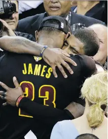  ?? ERIC RISBERG/THE ASSOCIATED PRESS/FILES ?? Cavaliers forward LeBron James hugs Kyrie Irving after Game 7 of the NBA Finals against the Golden State Warriors in Oakland in last June. The Cavaliers won 93-89.