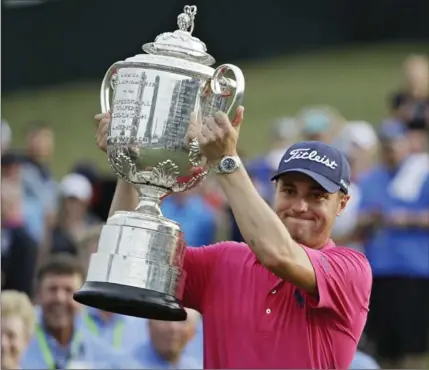  ?? CHRIS O’MEARA, THE ASSOCIATED PRESS ?? Justin Thomas poses with the Wanamaker Trophy after winning the PGA Championsh­ip golf tournament at the Quail Hollow Club on Sunday.