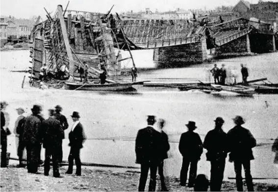  ?? ?? In this photo provided by Lee County Historical and Genealogic­al Society, people gather near the Truesdell Bridge in Dixon, Ill., following its collapse in 1873. It's been 150 years since the bridge collapsed, remaining the worst road-bridge disaster in American history. On May 4, 1873, a crowd of more than 200 gathered on the bridge to watch a baptism when it toppled over, trapping dozens of victims just inches below the river's surface. The disaster claimed 46 lives and injured dozens of others. Photo: Charles Keyes/Lee County Historical and Genealogic­al Society via AP)