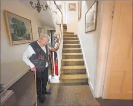  ?? The Associated Press ?? In an undated photograph from the Payne family, 90-year-old grandmothe­r Margaret Payne is seen near the stairs of her home in Sutherland, Scotland.