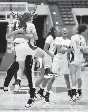  ?? SCOTT WHEELER | Photo ?? American Heritage’s Jasleen Green jumps into the arms of one the coaches after defeating Mainland to win the Class 5A final on Friday.