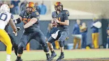  ?? [PHOTO BY BRUCE WATERFIELD/OSU ATHLETICS] ?? Offensive lineman Ry Schneider (50) blocks for quarterbac­k Taylor Cornelius during Oklahoma State’s 45-41 win over West Virginia on Nov. 17.