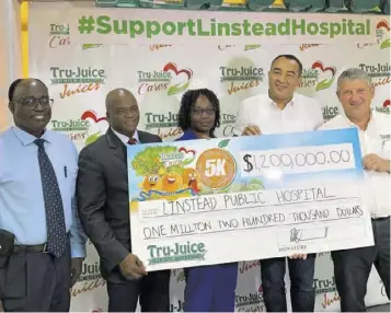  ??  ?? Peter Mcconnell (right), managing director Trade Winds Citrus Limited, presents a symbolic cheque of $1.2 million raised from the Tru-juice Cross Country 5K event to Paul Mcinytre (second left), acting chief executive officer, Linstead Hospital, while Dr Christophe­r Tufton (second right), minister of health and wellness;
Dr Clive Thomas (left), senior medical officer, Linistead Hospital; and Vivette Lawrence, director of nursing services, Linstead Hospital, look on at the ceremony last week Wednesday.